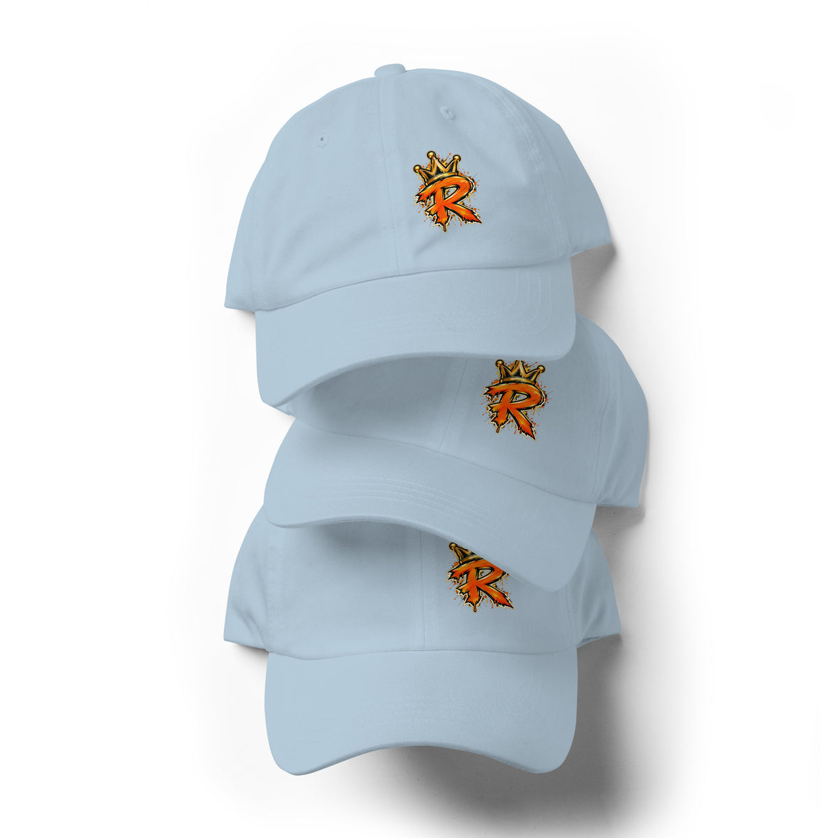 Three stacked light blue dad hats shown from the front with orange-and-gold crowned R logos