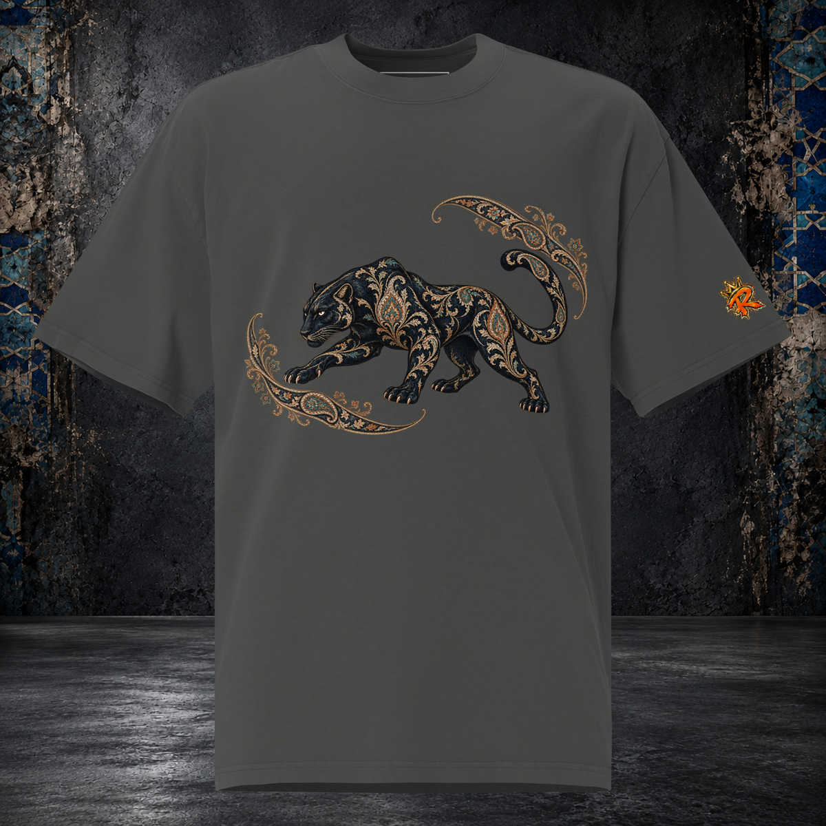 Front mockup of a faded coal oversized tee with a black panther, gold-toned ornament and curling paisley flourishes