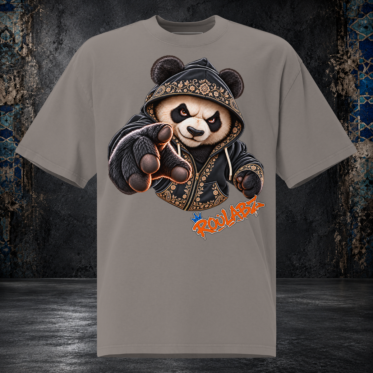 Front mockup of a faded grey oversized tee with a panda in a patterned hood reaching one gloved paw forward