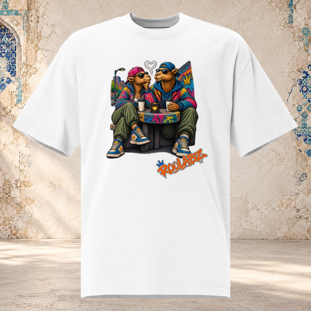 Front mockup of a faded white Camel Date oversized tee with two camel characters seated together beside drinks