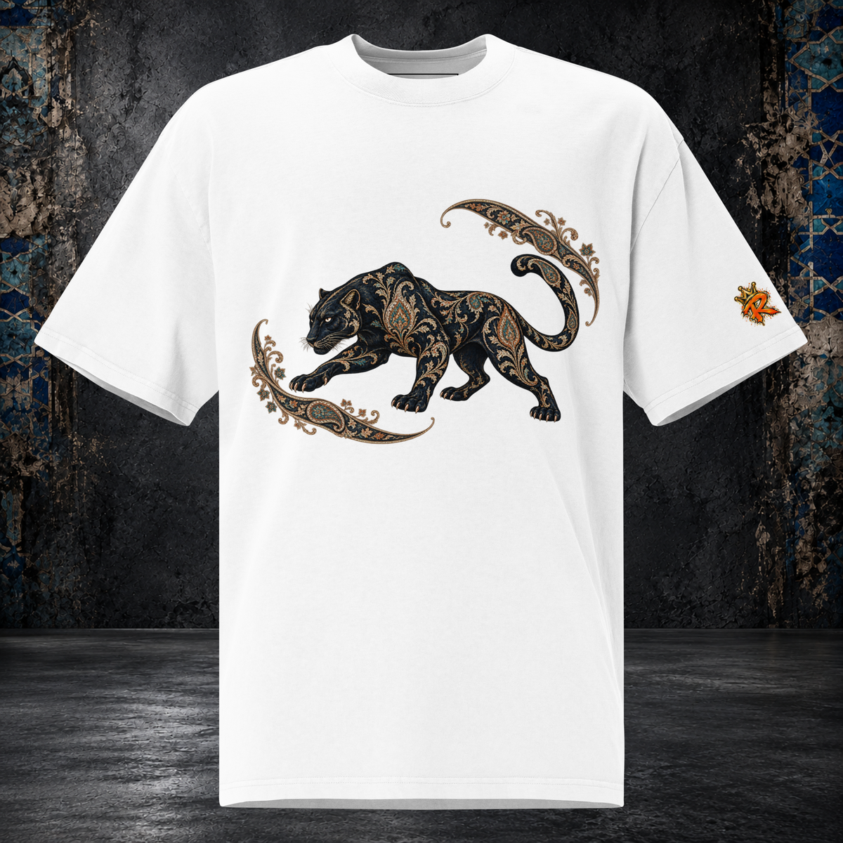 Front mockup of a faded white oversized tee with a black panther, gold-toned ornament and curling paisley flourishes