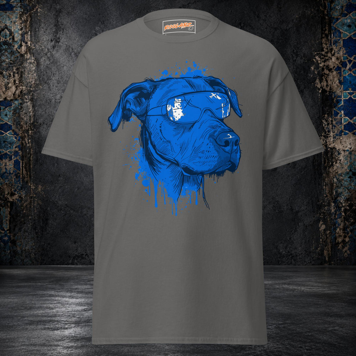 Front mockup of a charcoal tee with an electric-blue dog portrait, white-patterned bandana and dripping ink details