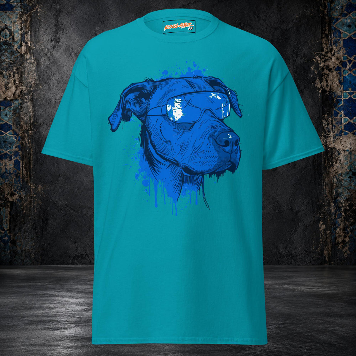 Front mockup of a tropical blue tee with an electric-blue dog portrait, white-patterned bandana and dripping ink details