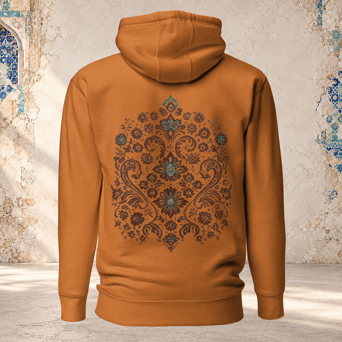 Back mockup of an adobe Verdigris Garden hoodie with an ornate teal and brown floral medallion