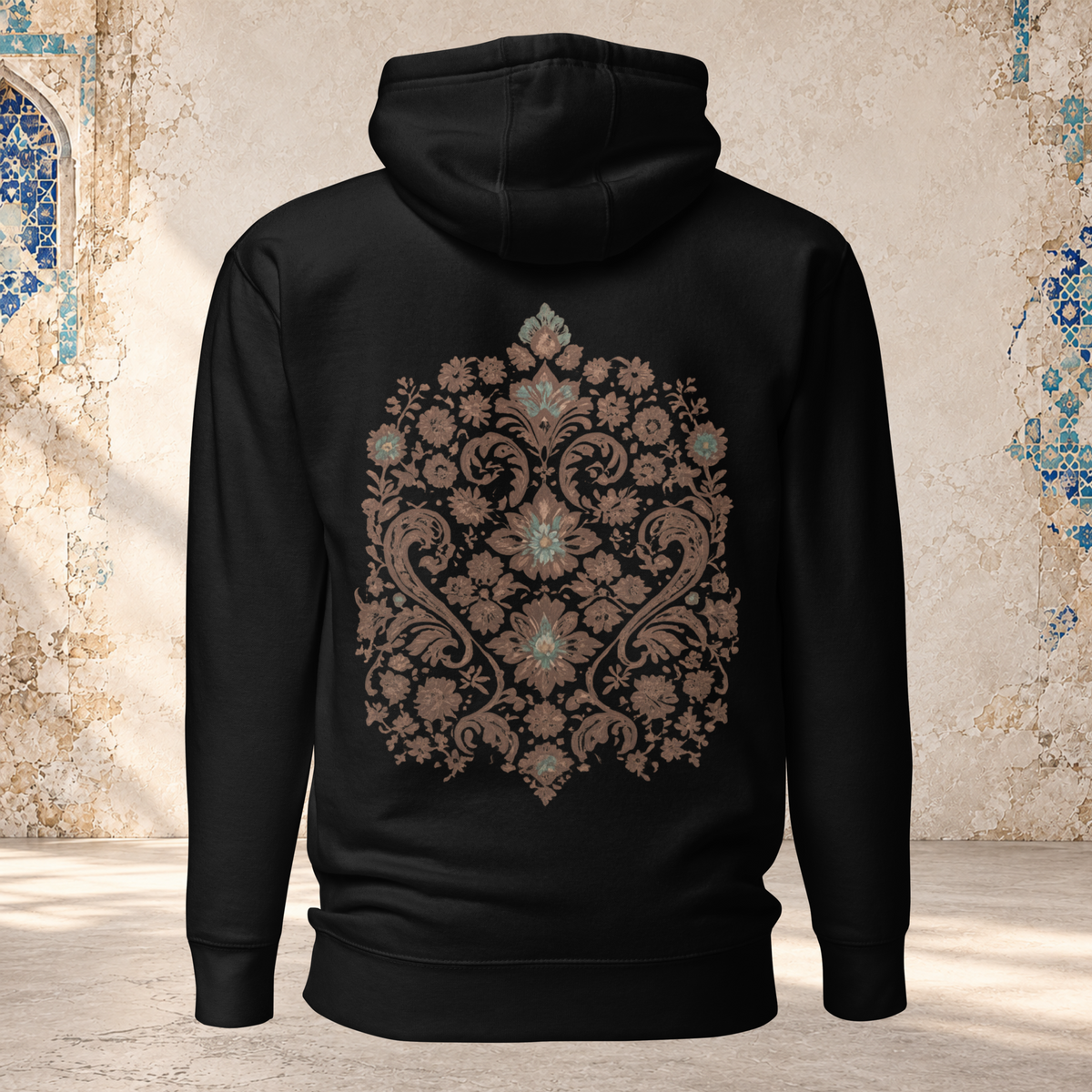 Back mockup of a black Verdigris Garden hoodie with an ornate teal and brown floral medallion