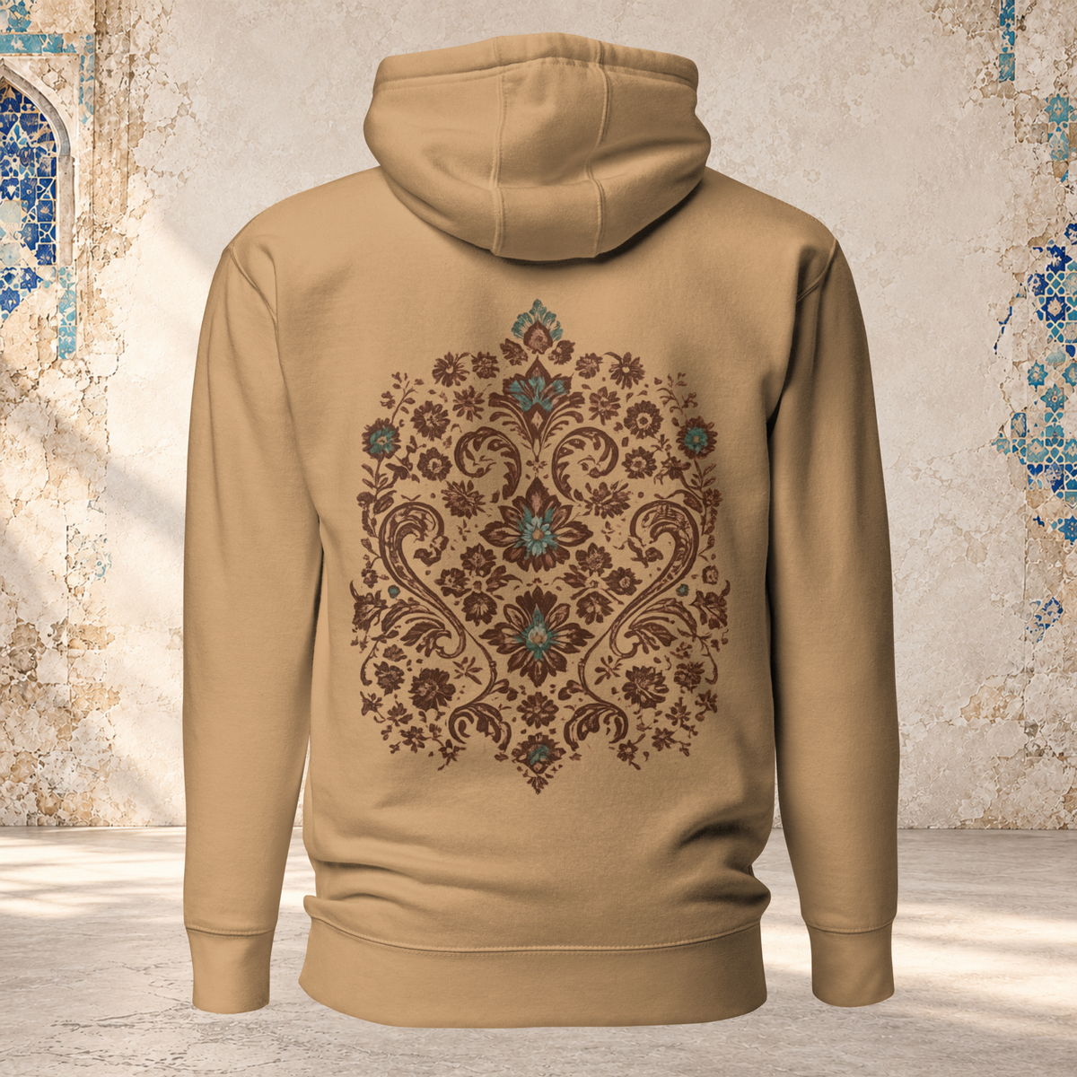 Back mockup of a khaki Verdigris Garden hoodie with an ornate teal and brown floral medallion