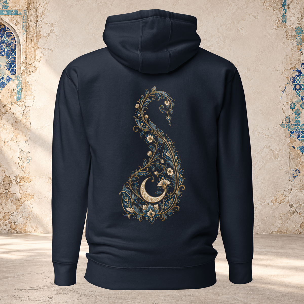 Back view of a navy pullover hoodie with a gold and ivory Persian paisley holding a crescent moon
