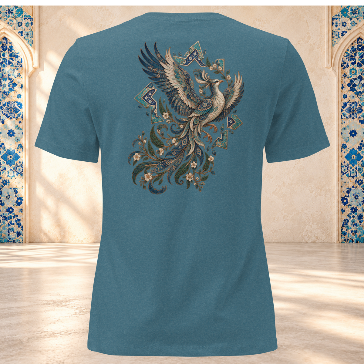 Back mockup of a heather deep teal women's tee with an ornate Persian phoenix, raised wings and a sweeping teal and gold tail