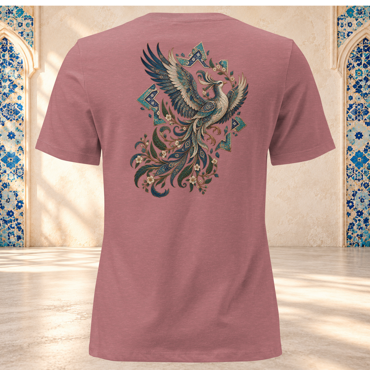 Back mockup of a heather mauve women's tee with an ornate Persian phoenix, raised wings and a sweeping teal and gold tail
