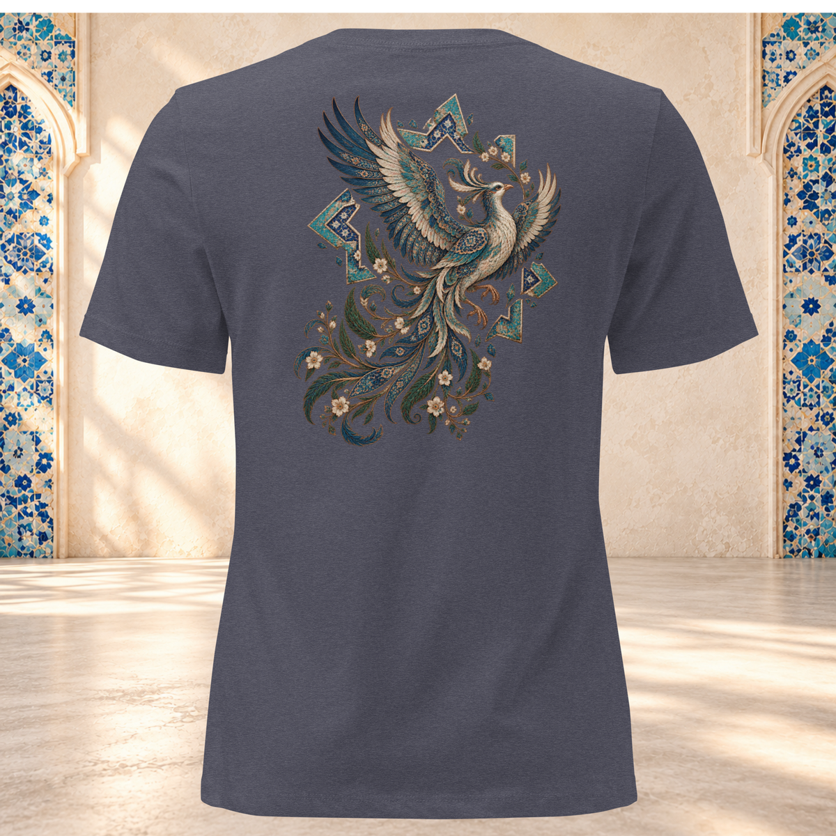 Back mockup of a heather navy women's tee with an ornate Persian phoenix, raised wings and a sweeping teal and gold tail