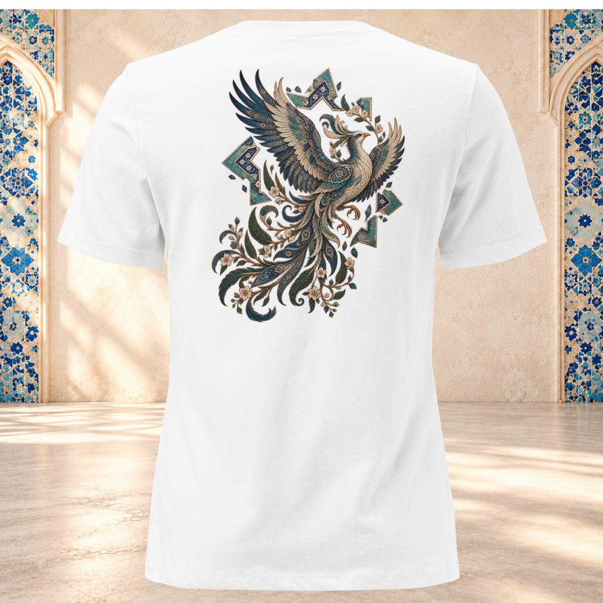 Back mockup of a white women's tee with an ornate Persian phoenix, raised wings and a sweeping teal and gold tail