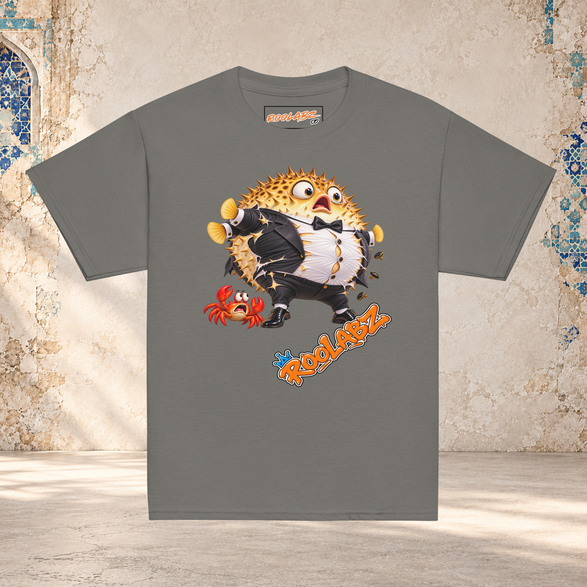 Front mockup of a charcoal youth tee with a puffed-up pufferfish bursting out of a black and white tuxedo