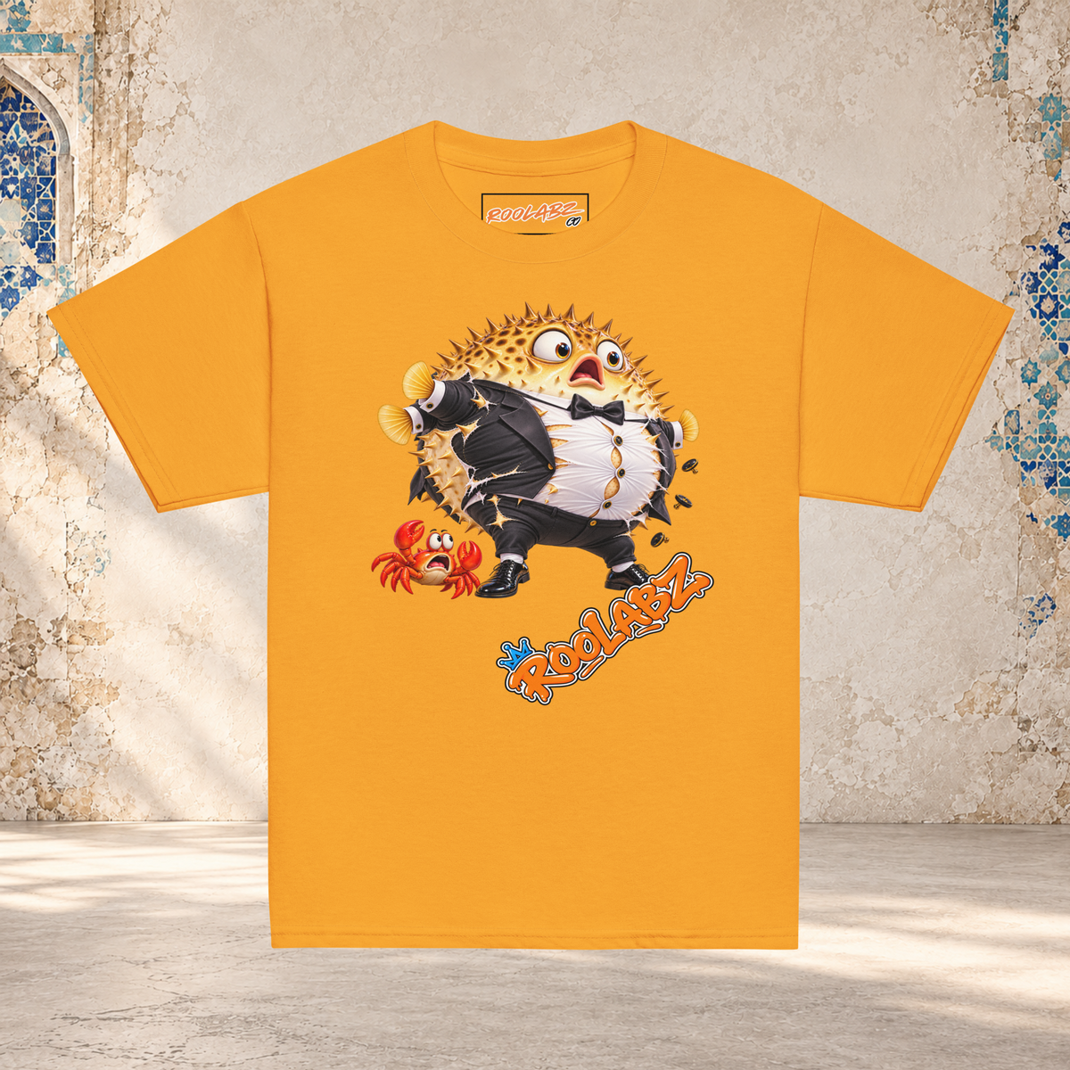 Front mockup of a gold youth tee with a puffed-up pufferfish bursting out of a black and white tuxedo