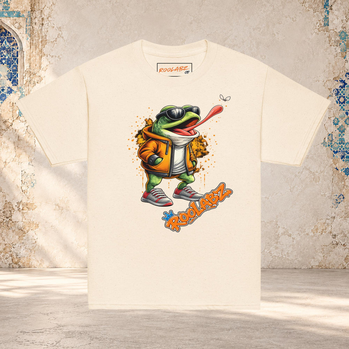 Front mockup of a natural youth tee with a frog in sunglasses reaching its tongue toward a fly