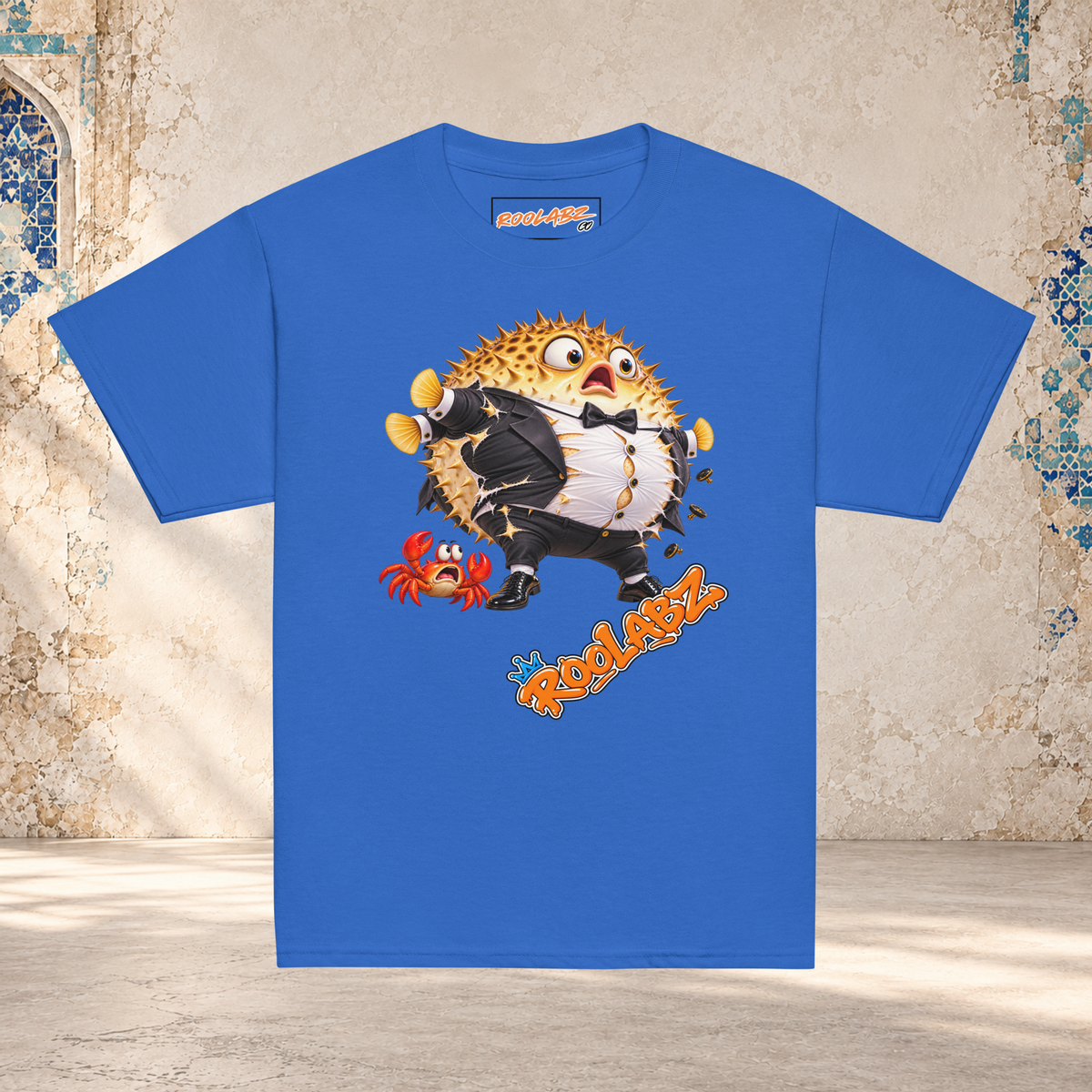 Front mockup of a royal youth tee with a puffed-up pufferfish bursting out of a black and white tuxedo